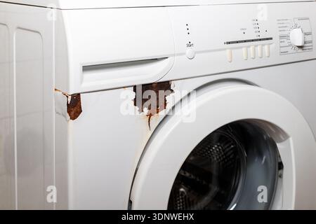Rust on surface of washing machine. Home appliances wear. Stock Photo
