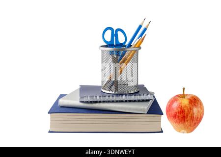 School accessories, stack of books and red apple isolated on white background. Education concept. Stock Photo