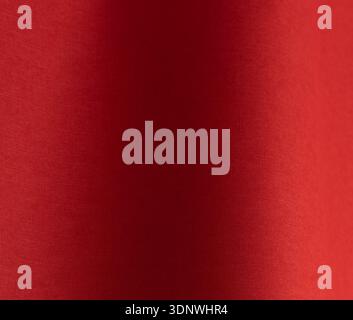 Red textured paper background with smooth tonal gradient. Matte surface with fine rough grain and saturated warm color. Minimal abstract backdrop for Stock Photo