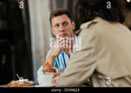 Business colleagues having coffee break discussing work Stock Photo