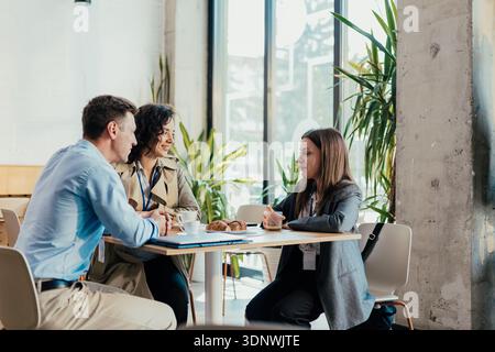 Business professionals discussing work at a coffee break Stock Photo