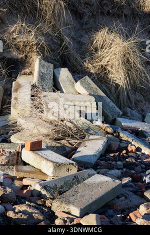 Pile of concrete block rubble as base of sand dunes Stock Photo