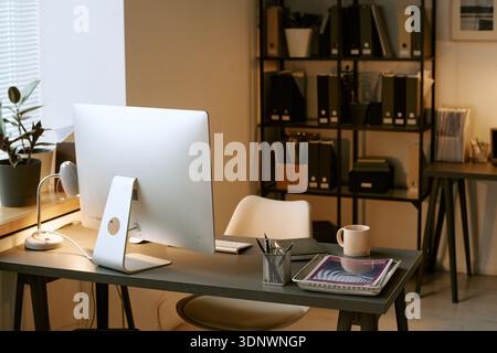 Modern Office Workspace Featuring Desktop Computer and Digital Tablet on Desk Stock Photo