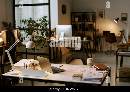 Modern Business Office Workspace Featuring Laptop and Documents on Desk Stock Photo