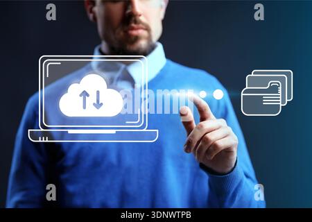 Man using technology to manage cloud services and data transfer on a laptop screen Stock Photo