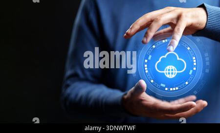 Hands hold a glowing cloud symbol with a globe, showing digital connection and technology use Stock Photo