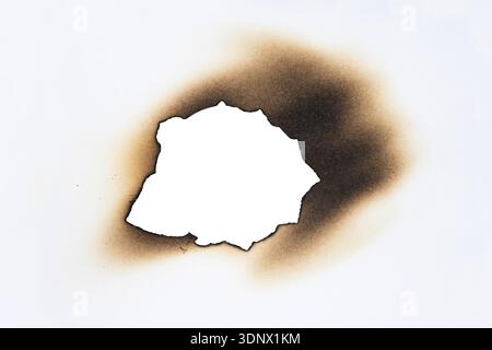 Burned Hole with Brown Edges in Paper Isolated on White Background Stock Photo