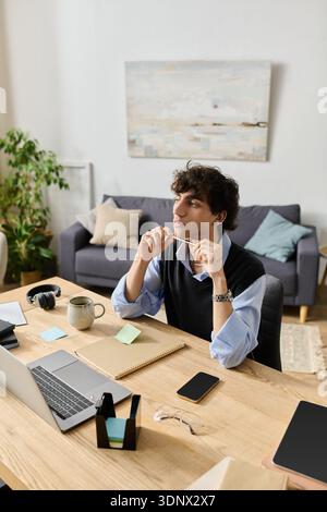 A young man with curly hair admires his stylish surroundings while brainstorming ideas. Stock Photo