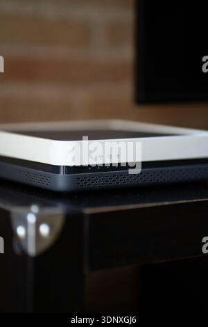 Wireless modem router with illuminated status lights providing high-speed internet connection for home or office networking and digital communication Stock Photo