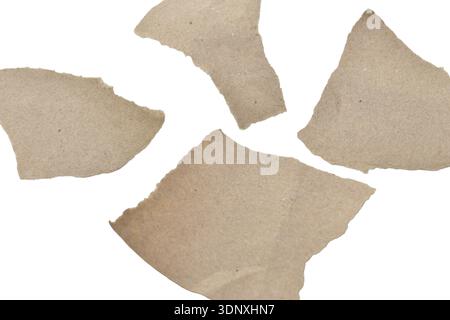 Shapeless shreds of hand-torn wrapping paper lie on a white background. Stock Photo