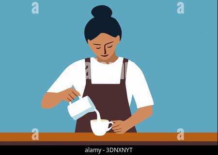 A woman with dark hair in a bun pours warm milk into a white coffee cup while standing at a wooden counter in a bright cafe. The setting is inviting a Stock Photo