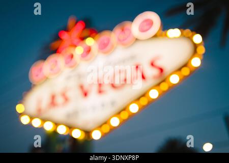 Blurred image of the famous Welcome to Las Vegas sign, glowing vibrantly at night. The classic Las Vegas symbol welcomes visitors to the bustling city Stock Photo