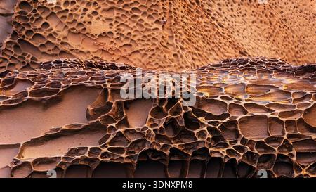 Captivating image of sandstone rock formations shaped by water erosion on Asturias eastern coast. The intricate patterns form vivid, beautiful shapes Stock Photo