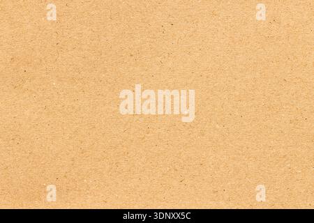 Close-up of a brown kraft paper with a fine texture, showcasing a natural and earthy feel. Perfect for designs needing an organic, recycled look. Stock Photo