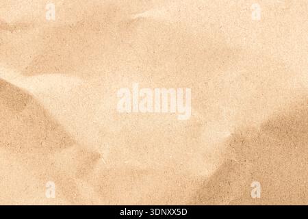 A high-resolution image showcasing a kraft paper texture with a soft, natural pattern. The light brown surface provides a rustic and organic feel, ide Stock Photo