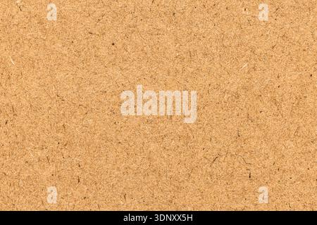 A close-up of natural kraft paper showcasing an earthy brown tone and fibrous texture. Ideal for backgrounds or craft projects, this texture adds a ru Stock Photo