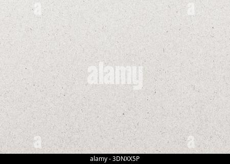 A close-up of a white paper texture featuring a subtle, even surface with tiny speckles. Perfect for design backdrops or artistic projects needing a m Stock Photo