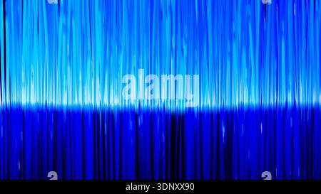 The scene showcases dynamic technological fibers in bright shades of blue and purple, creating a visually stunning and abstract background. Stock Photo