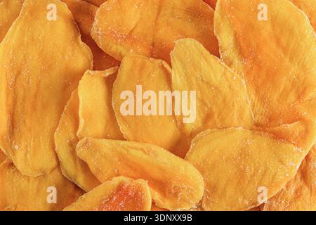 Top view of vibrant orange dried mango slices, arranged closely together Stock Photo