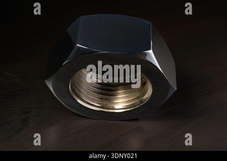 Large industrial nut with a dark background Stock Photo