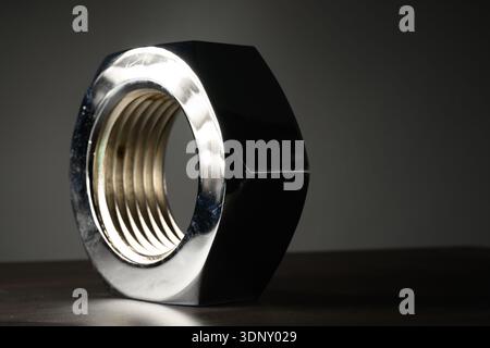 Large industrial nut with a dark background Stock Photo