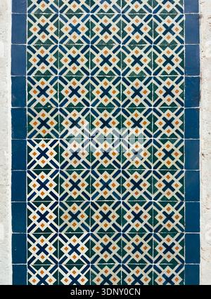 Vibrant traditional azulejos from Lisbon showcasing detailed geometric patterns in blue, green, and orange hues. These tiles capture the essence of Po Stock Photo