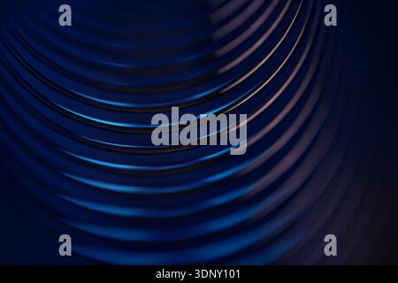 Abstract image showcasing curved metal spirals with a blue neon glow on a dark background. The spirals create a sense of depth and dynamic movement. Stock Photo