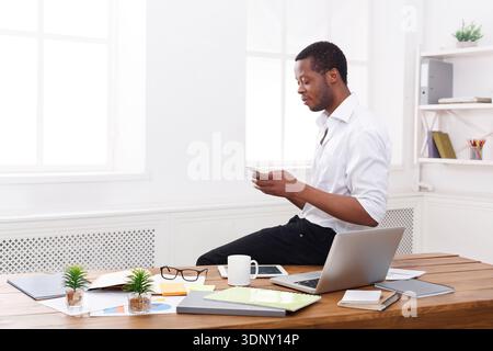 Young black businessman making a phone call on mobile Stock Photo