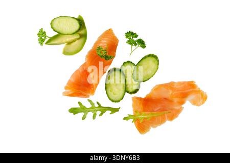 Smoked salted salmon filet slice with cucumber, herbs and spices isolated on white background. Top view card Stock Photo