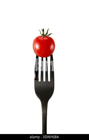 Fresh red cherry tomato on black fork isolated on white background Stock Photo