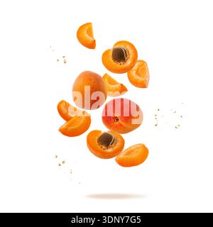 Fresh ripe whole and sliced apricot fruits with juice drops flying falling isolated on white background. Flying food collection. Stock Photo