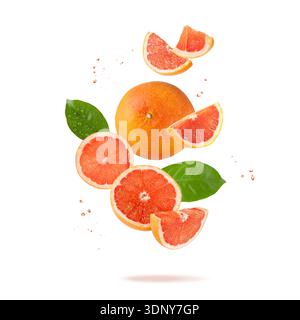 Fresh grapefruit fruit whole and slices with drops and leaves falling flying isolated on white background Stock Photo