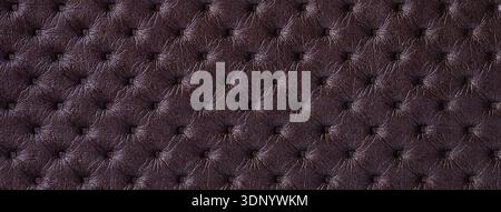 Dark purple leather texture with capitone pattern, macro background of brown retro Chesterfield vintage textile fabric. Stock Photo