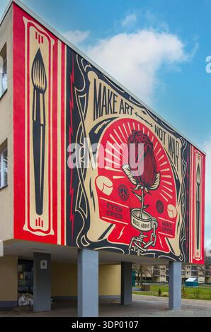 Large street art mural "Make Art Not War" created American street artist Shepard Fairey, known as Obey Giant  a stylized red rose, berlin, germany Stock Photo