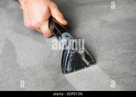 Professional cleaning of the upholstery on a sofa Stock Photo