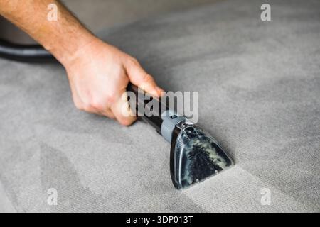 Professional cleaning of the upholstery on a sofa Stock Photo