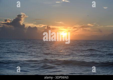Sunrise with the sun shining through the clouds on Florida's Atlantic coast Stock Photo