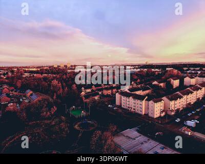Aerial sunrise view over residential housing estate and autumn foliage in Barlanark, East End Glasgow, Scotland, United Kingdom. Stock Photo