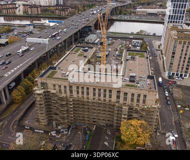 Aerial view of construction and urban regeneration beside the River Clyde and elevated motorway in Glasgow, Scotland. Stock Photo