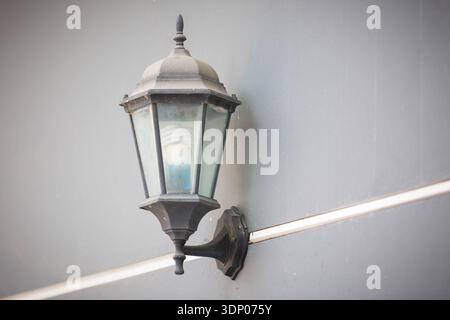 Light bulb and lamp on gray brick wall background as interior design concept. Stock Photo