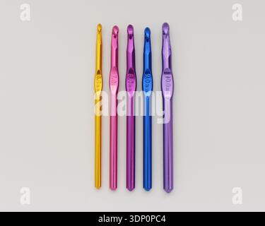 Colorful Crochet Hooks in a Row on White Table, Top View Flat Lay Stock Photo
