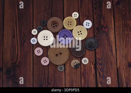 Colorful Buttons Scattered on Wooden Table, Top View Flat Lay Stock Photo