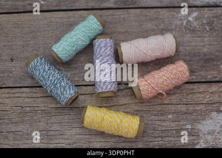 Colorful Spools of Thread on Wooden Table, Top View Flat Lay Stock Photo