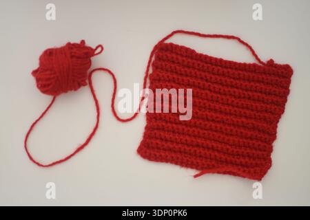 Red Crochet Yarn Piece on White Table, Top View Flat Lay Stock Photo