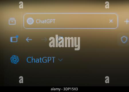 Close up of a computer screen showing a ChatGPT browser tab and AI logo on a warm golden background, representing artificial intelligence technology, Stock Photo