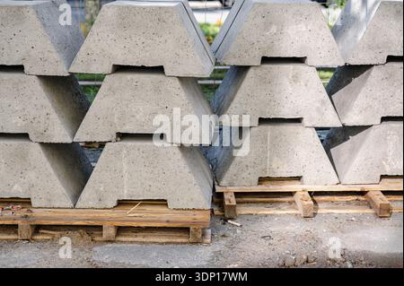 Rows of stacked gray concrete paving blocks with rough surfaces and layered textures. High quality photo Stock Photo