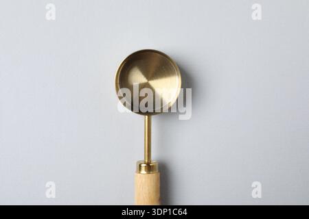 Golden scoop on light background, top view Stock Photo