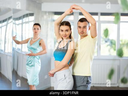 Positive man and woman practicing samba in dance class Stock Photo