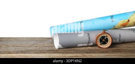 Journey. Compass and world maps on wooden table against white background Stock Photo