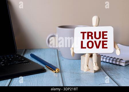 The text True Love appearing behind torn brown paper Stock Photo